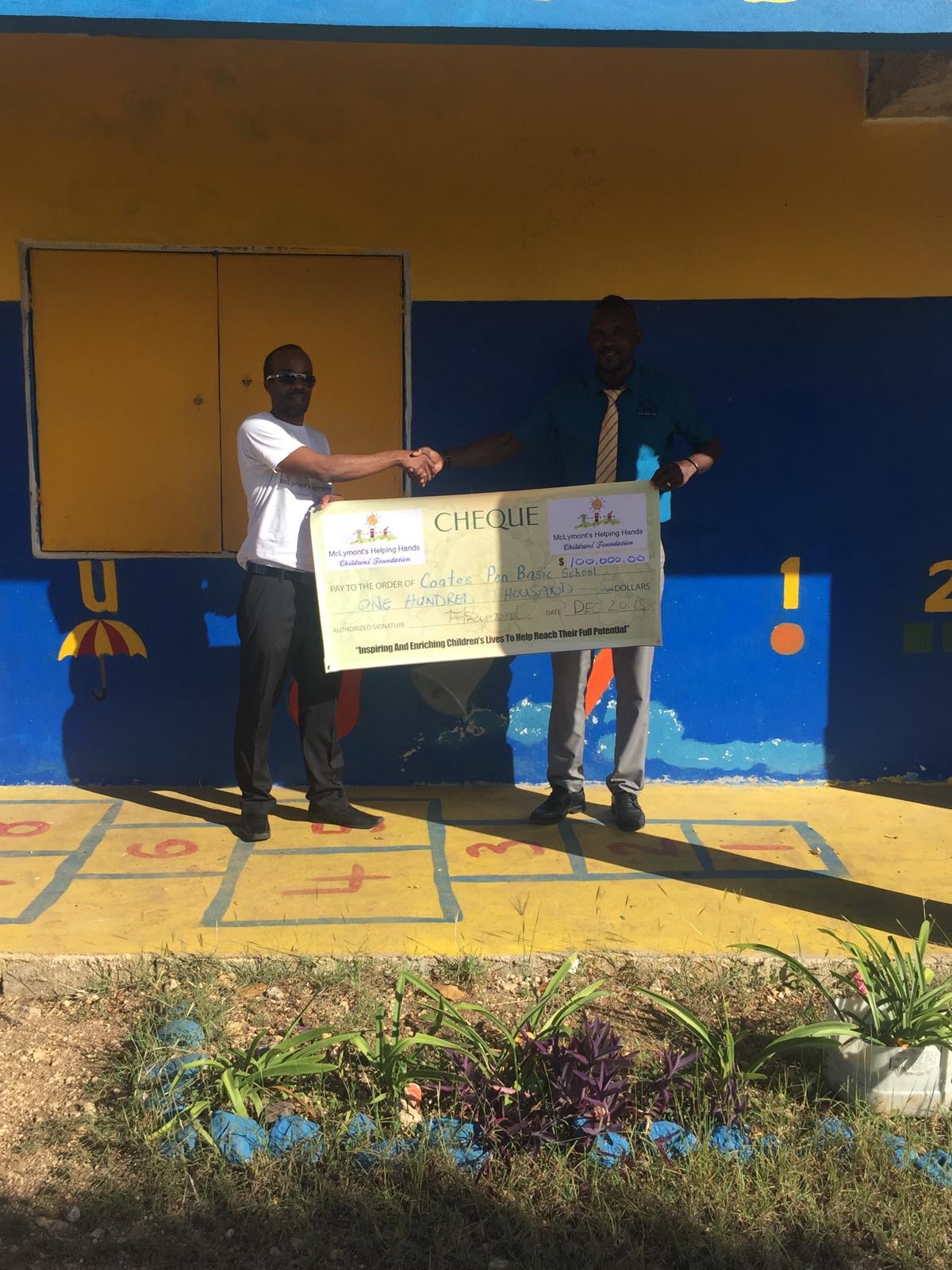 Foundation representative presenting a ceremonial cheque to a school representative